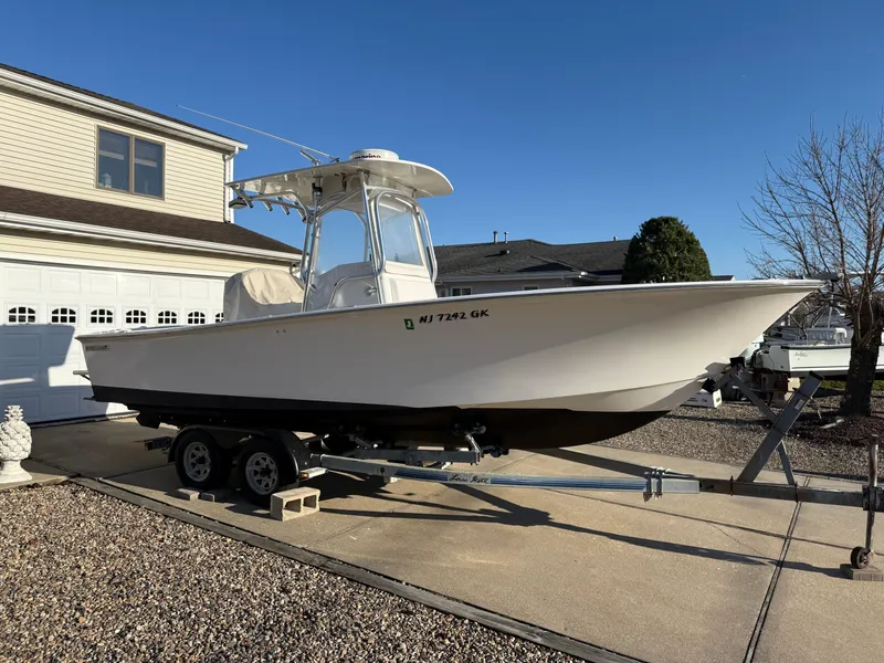 Slide: The Image of 2001 Silverhawk 24 Center Console boat on trailer in driveway, sunny day. - 1