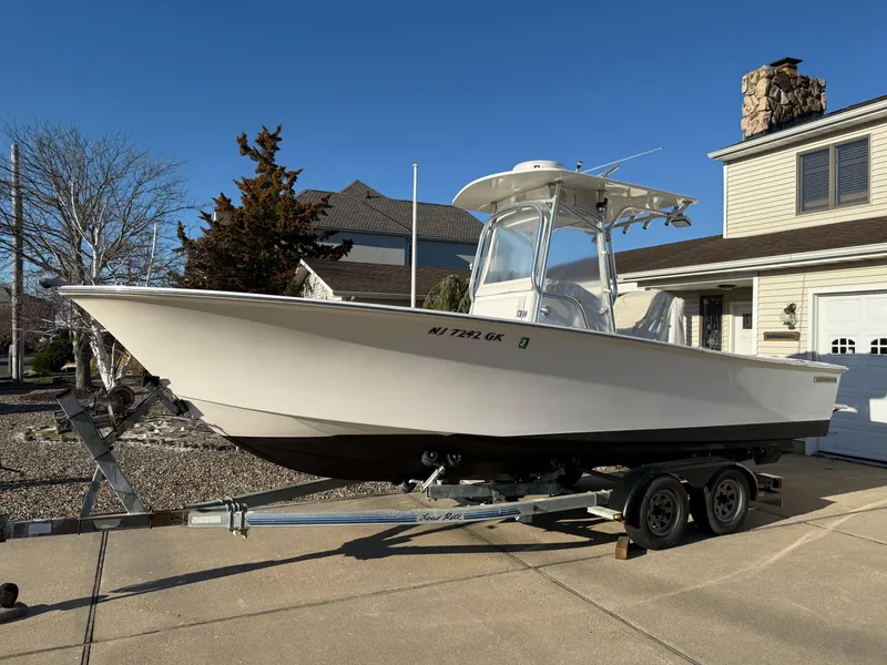Slide: The Image of 2001 Silverhawk 24 Center Console boat on trailer in residential driveway. - 11