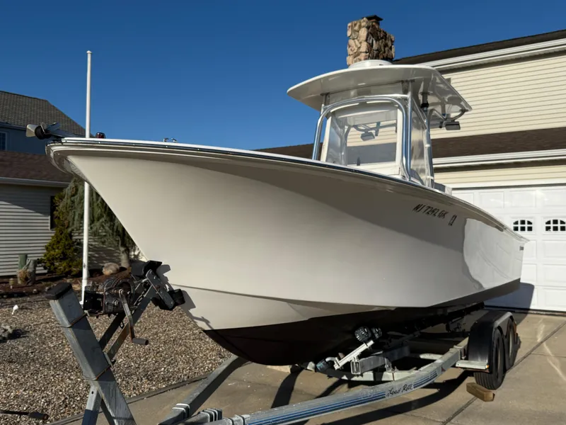 Slide: The Image of 2001 Silverhawk 24 Center Console boat on trailer, parked in driveway. - 12