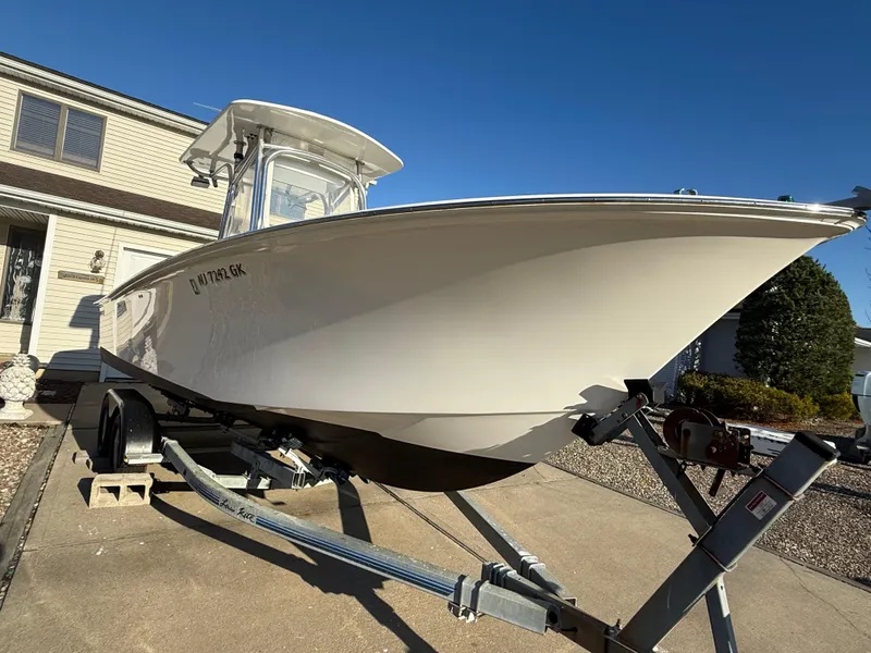 Slide: The Image of 2001 Silverhawk 24 Center Console boat on trailer, parked in driveway. - 13