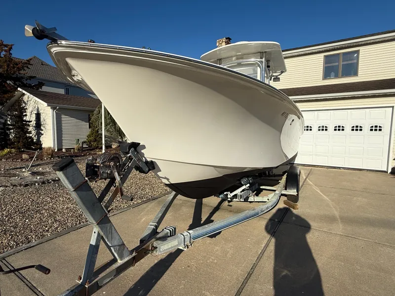 Slide: The Image of 2001 Silverhawk 24 Center Console boat on trailer in driveway, sunny day. - 14