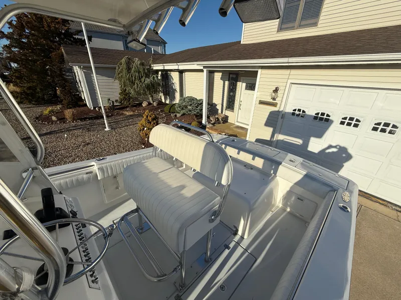 Slide: The Image of 2001 Silverhawk 24 Center Console boat parked in a residential driveway. - 18