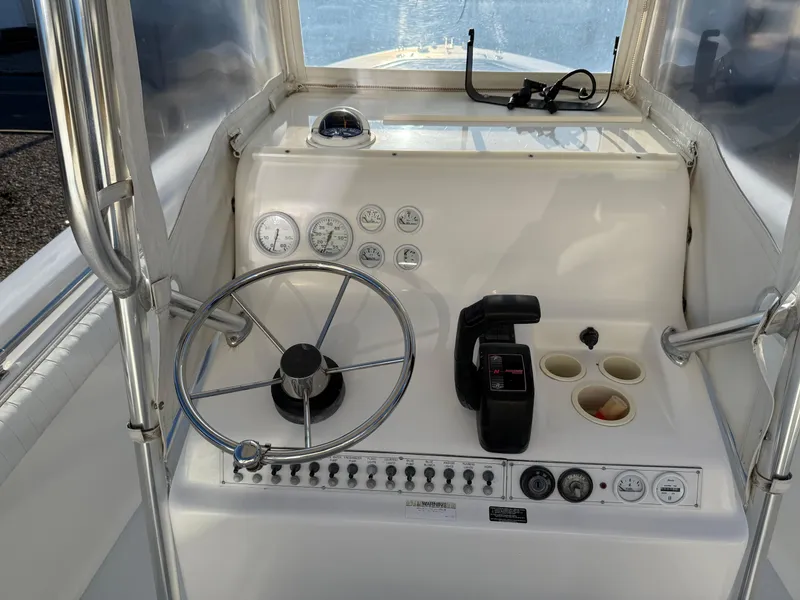 Slide: The Image of 2001 Silverhawk 24 Center Console boat dashboard with steering wheel and controls. - 23