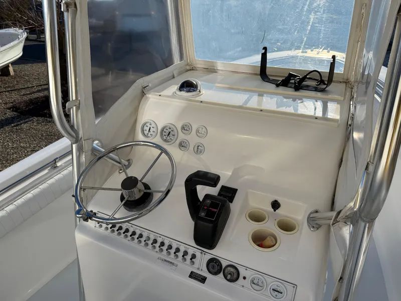 Slide: The Image of 2001 Silverhawk 24 Center Console boat dashboard with steering wheel and controls. - 24