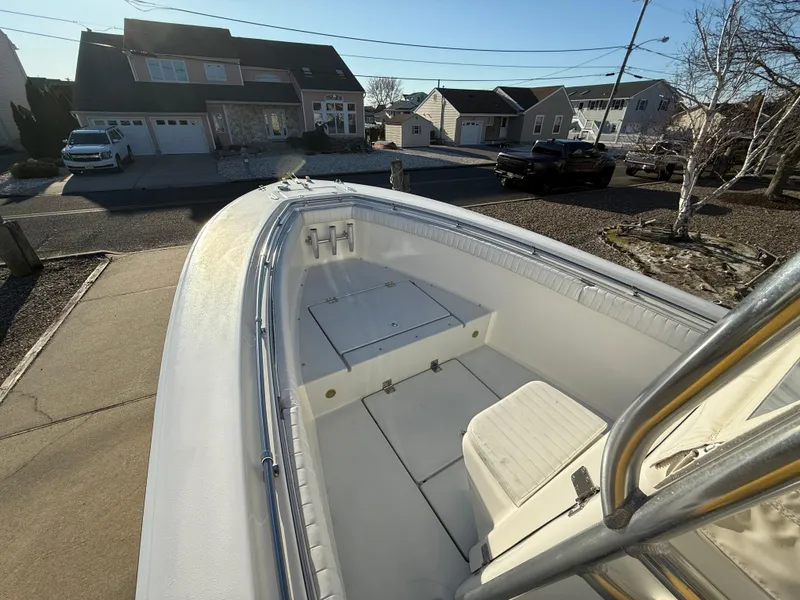 Slide: The Image of 2001 Silverhawk 24 Center Console boat parked in a residential driveway. - 25
