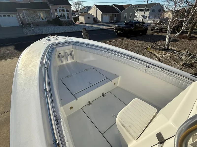 Slide: The Image of 2001 Silverhawk 24 Center Console boat, white interior, residential street background. - 27
