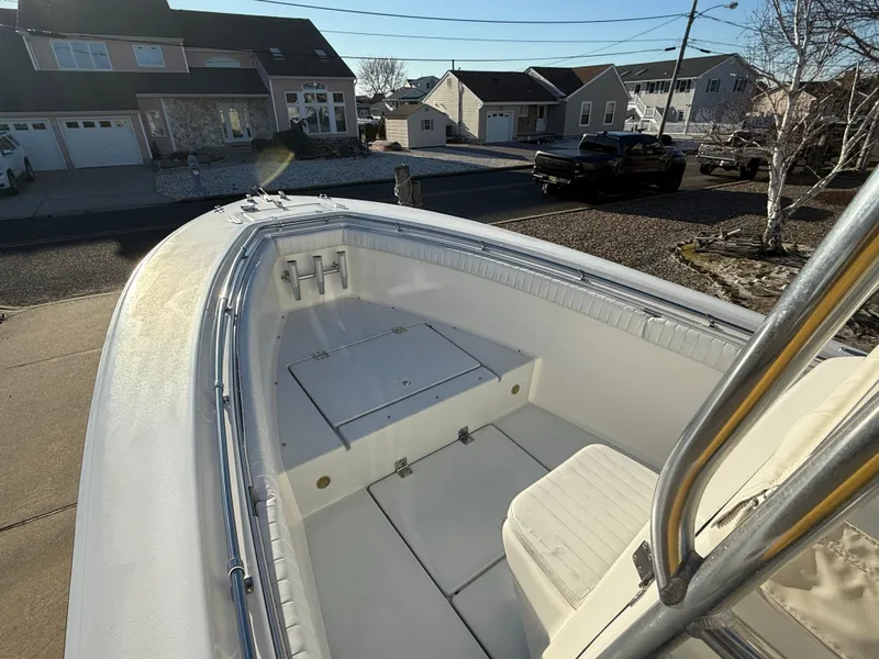 Slide: The Image of 2001 Silverhawk 24 Center Console boat docked in a residential area. - 28