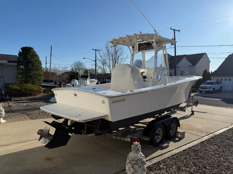 Slide: The Image of 2001 Silverhawk 24 Center Console boat on trailer in suburban driveway. - 3