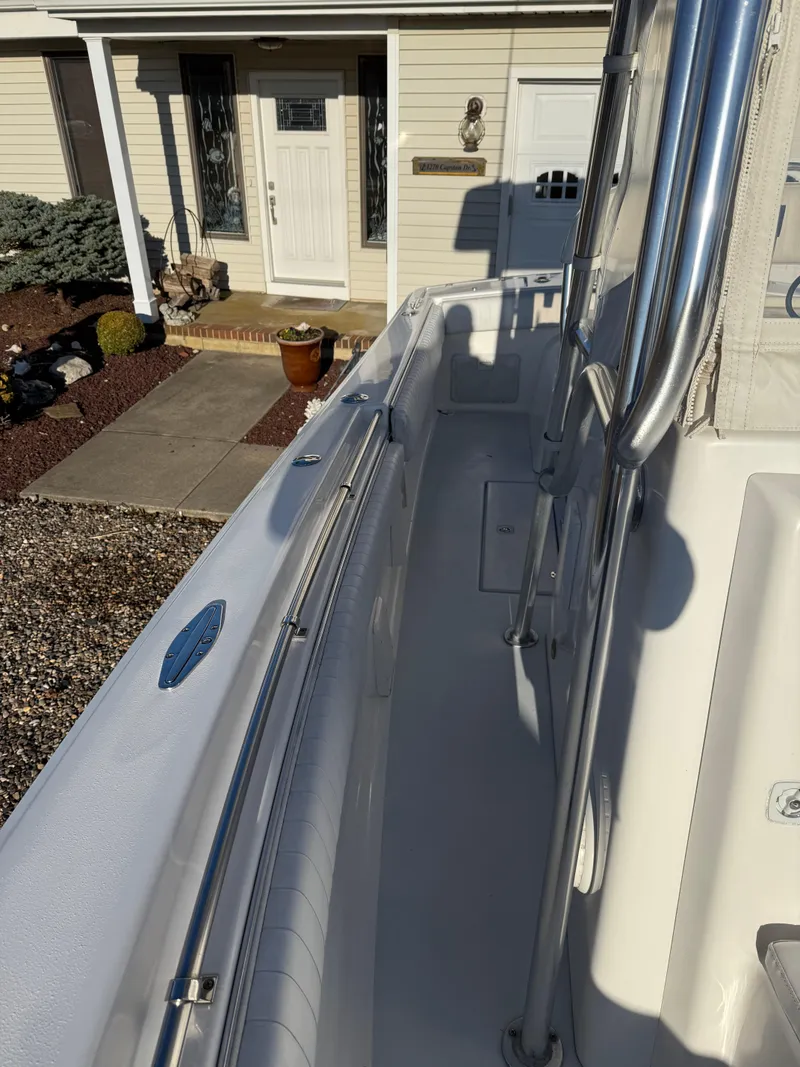 Slide: The Image of 2001 Silverhawk 24 Center Console boat docked near a house entrance. - 33