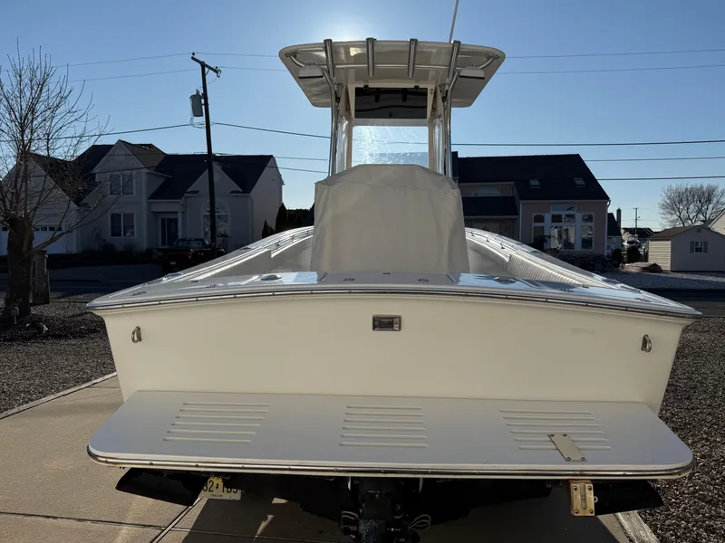 Slide: The Image of 2001 Silverhawk 24 Center Console boat on a driveway, rear view. - 4