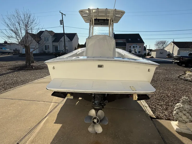 Slide: The Image of 2001 Silverhawk 24 Center Console boat on driveway, rear view with propeller visible. - 5