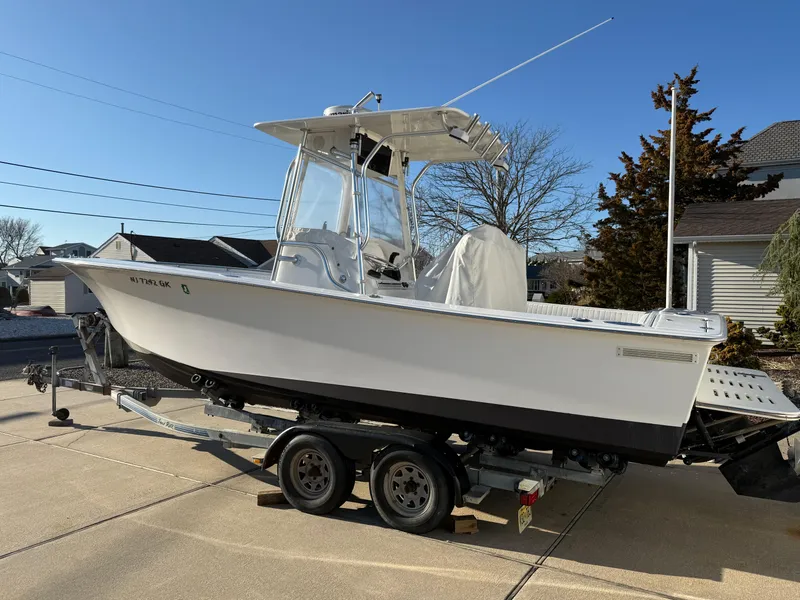 Slide: The Image of 2001 Silverhawk 24 Center Console boat on trailer, parked in driveway. - 9