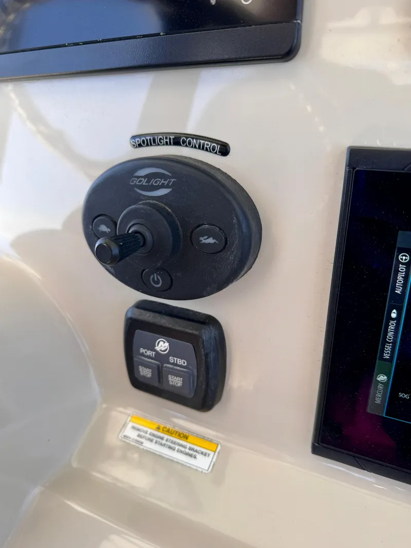 Slide: The Image of Control panel of 2018 Boston Whaler 330 Outrage boat with spotlight controls. - 11