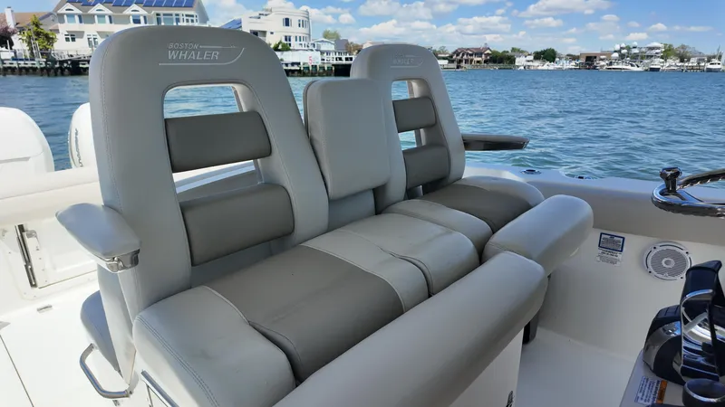 Slide: The Image of 2018 Boston Whaler 330 Outrage boat seats with waterfront view. - 12