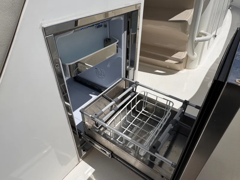 Slide: The Image of Open storage compartment on a 2018 Boston Whaler 330 Outrage boat. - 17