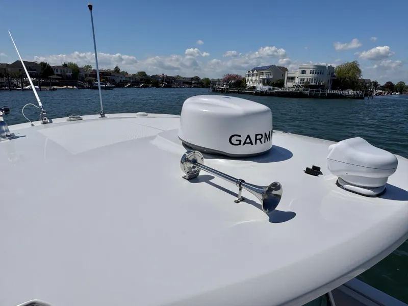 Slide: The Image of 2018 Boston Whaler 330 Outrage boat with Garmin radar on calm water. - 21
