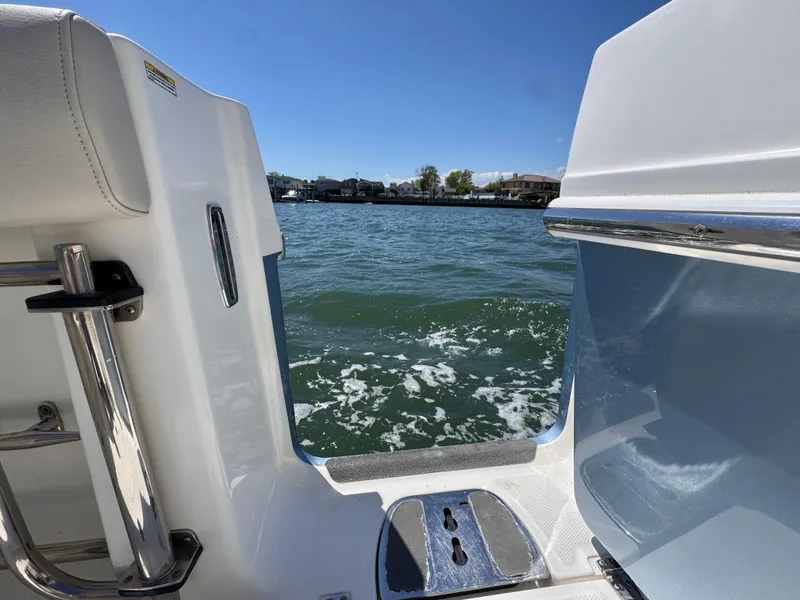 Slide: The Image of 2018 Boston Whaler 330 Outrage boat on water, showcasing sleek design and open sea view. - 22