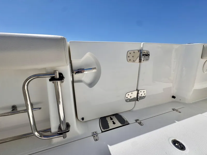 Slide: The Image of 2018 Boston Whaler 330 Outrage boat deck with stainless steel railing and hatch. - 23