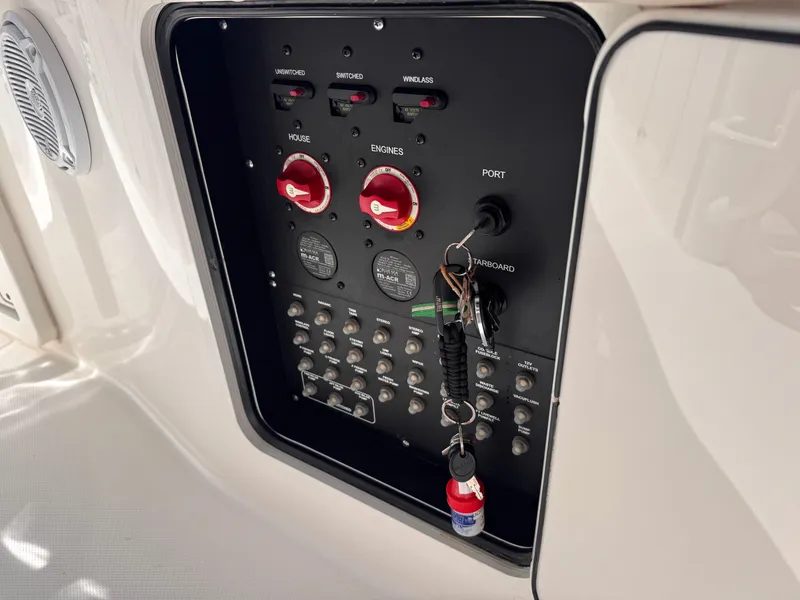 Slide: The Image of Control panel of a 2018 Boston Whaler 330 Outrage boat with switches and keys. - 31
