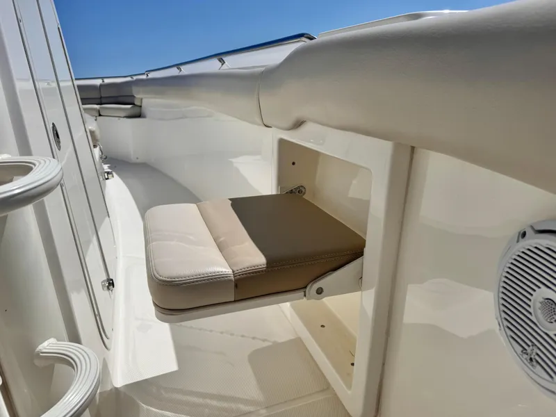 Slide: The Image of 2018 Boston Whaler 330 Outrage boat interior with foldable seat and speaker. - 32
