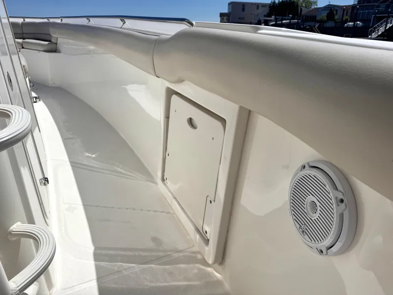 Slide: The Image of 2018 Boston Whaler 330 Outrage boat interior with speaker and seating area. - 33