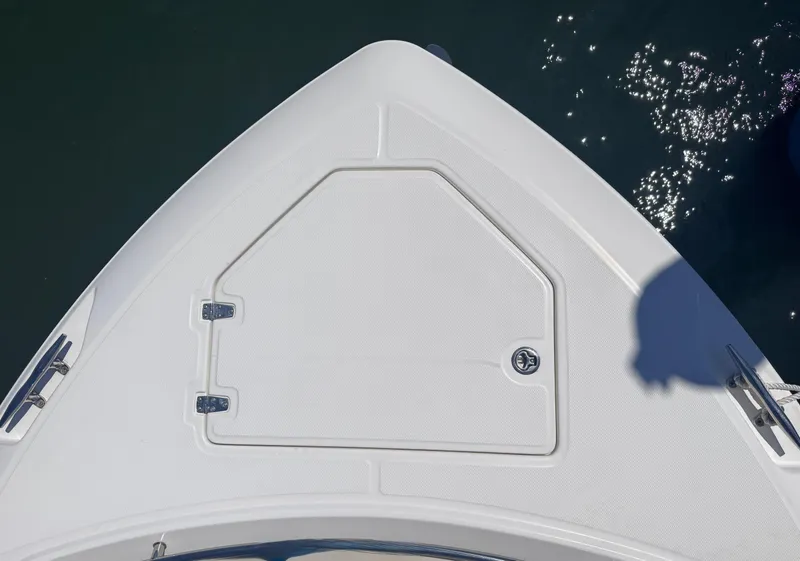 Slide: The Image of Bow of 2018 Boston Whaler 330 Outrage, featuring a storage hatch and sleek design. - 41