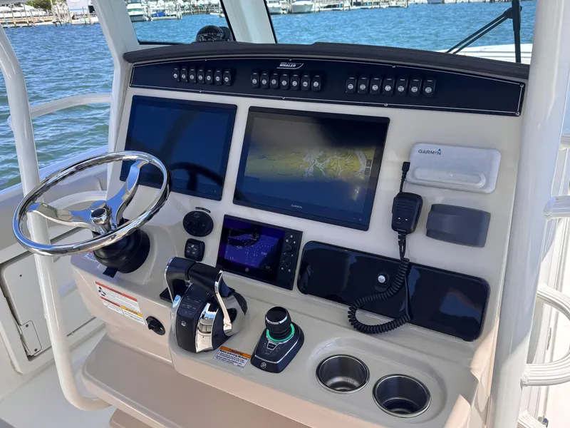 Slide: The Image of 2018 Boston Whaler 330 Outrage helm with navigation screens and controls. - 9