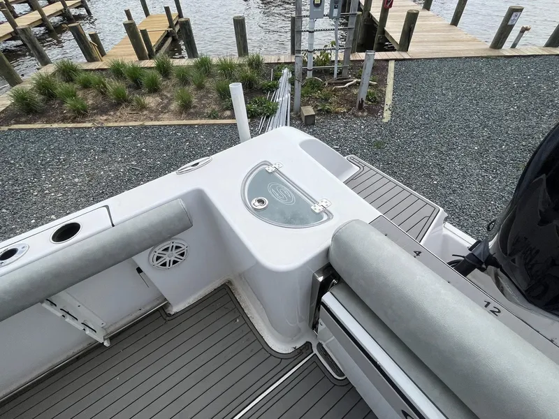 Slide: The Image of 2020 Sportsman Open 232 Center Console boat interior with seating and storage, dockside view. - 17