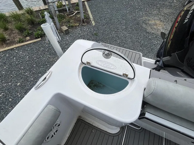 Slide: The Image of 2020 Sportsman Open 232 Center Console boat with livewell and seating area. - 18