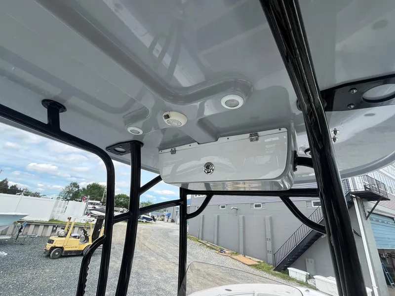 Slide: The Image of 2020 Sportsman Open 232 Center Console boat interior, featuring overhead storage and sleek design. - 19