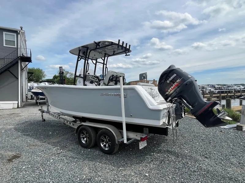 Slide: The Image of 2020 Sportsman Open 232 Center Console boat on trailer, parked outdoors. - 2