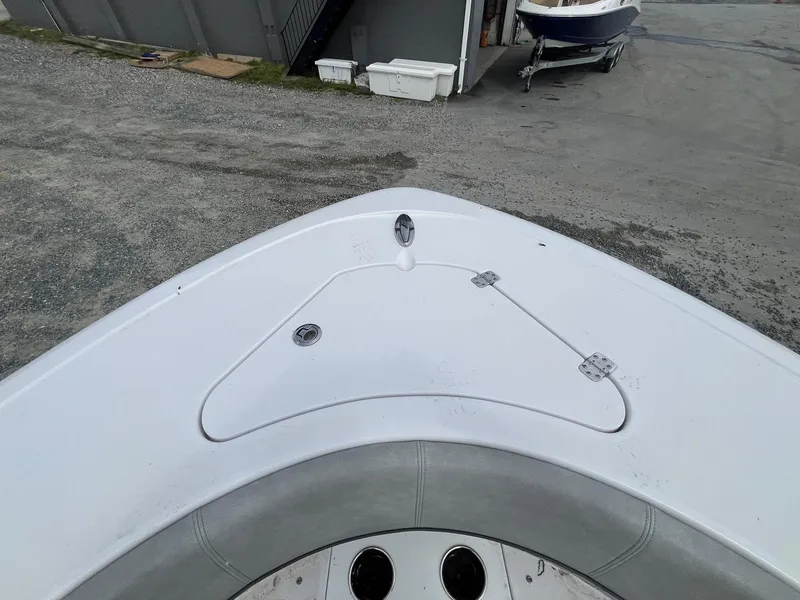 Slide: The Image of 2020 Sportsman Open 232 Center Console boat bow, featuring sleek design and storage hatch. - 22