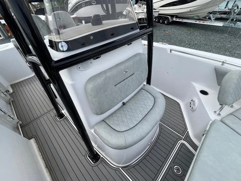 Slide: The Image of 2020 Sportsman Open 232 Center Console boat interior with cushioned seating and sleek design. - 9