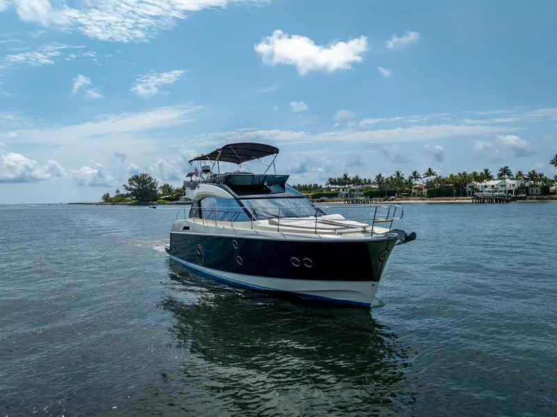 Slide: The Image of 2015 Beneteau Monte Carlo 5 yacht cruising on a sunny day near the coast. - 11
