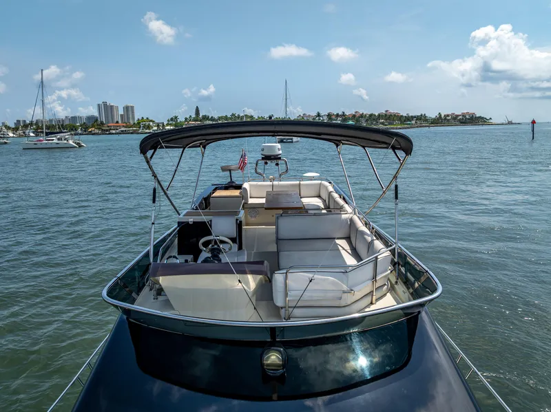 Slide: The Image of 2015 Beneteau Monte Carlo 5 yacht on water, featuring spacious deck and canopy. - 15