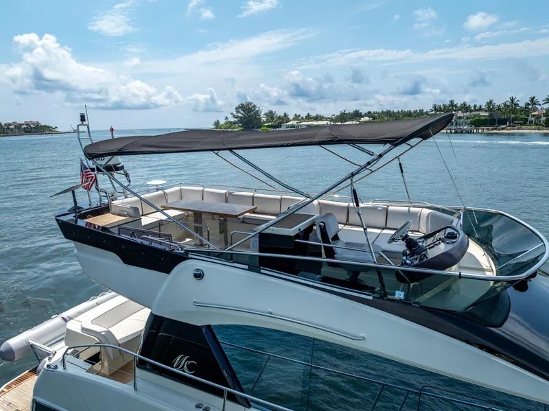 Slide: The Image of 2015 Beneteau Monte Carlo 5 yacht on serene water with clear skies. - 17