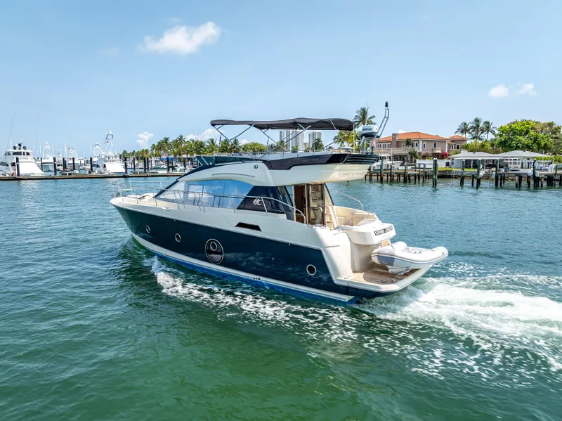 Slide: The Image of 2015 Beneteau Monte Carlo 5 yacht cruising in a sunny marina. - 23