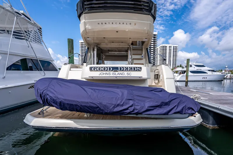 Slide: The Image of 2015 Beneteau Monte Carlo 5 yacht docked, rear view with covered equipment. - 29