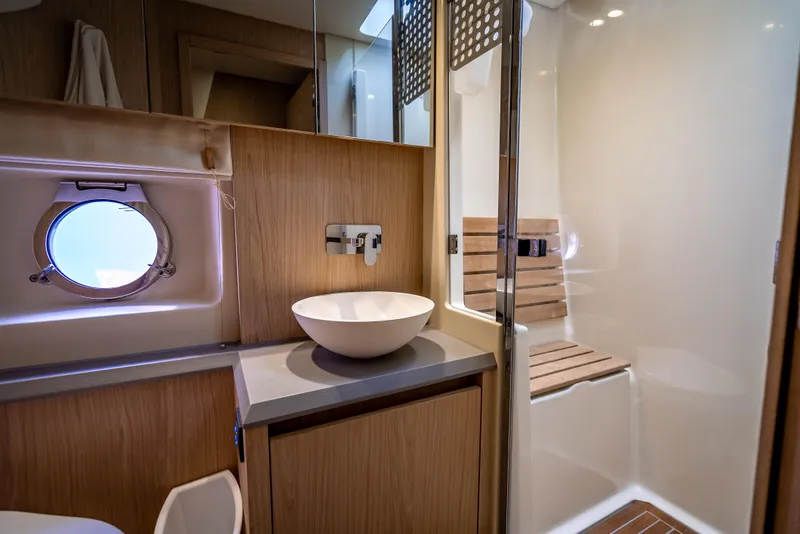 Slide: The Image of Luxurious bathroom in 2015 Beneteau Monte Carlo 5 yacht with modern fixtures and wooden accents. - 37