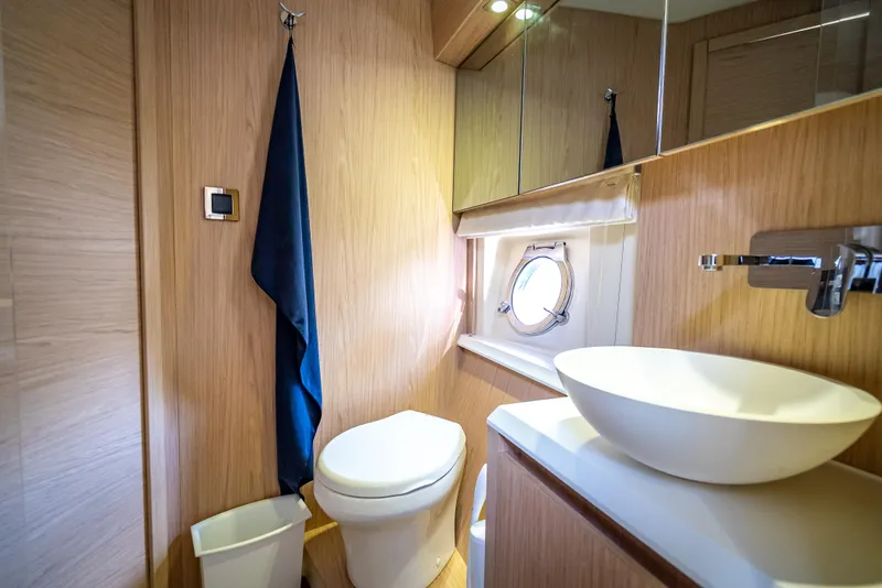 Slide: The Image of Luxurious bathroom in 2015 Beneteau Monte Carlo 5 yacht with modern fixtures and porthole. - 39