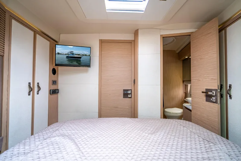Slide: The Image of Luxurious bedroom interior of 2015 Beneteau Monte Carlo 5 yacht with TV and ensuite bathroom. - 43