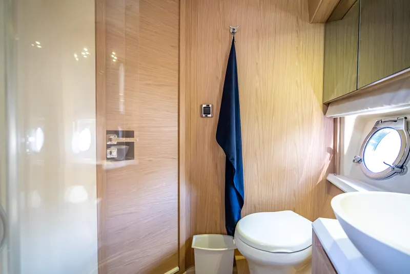 Slide: The Image of Luxurious bathroom in 2015 Beneteau Monte Carlo 5 yacht with modern fixtures and porthole window. - 44