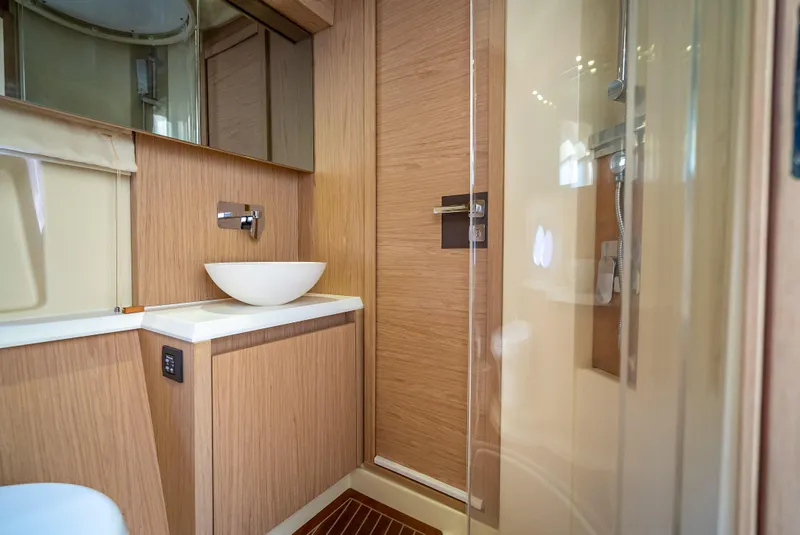Slide: The Image of Luxurious bathroom in 2015 Beneteau Monte Carlo 5 yacht with modern fixtures and wood accents. - 46