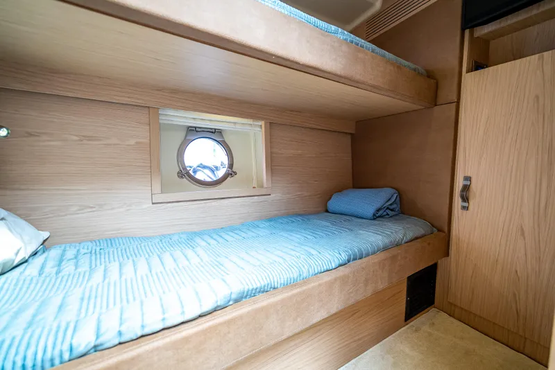 Slide: The Image of 2015 Beneteau Monte Carlo 5 cabin with bunk beds and porthole window. - 47