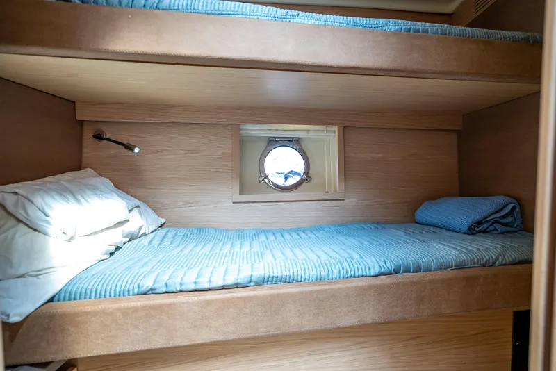 Slide: The Image of Bunk beds in 2015 Beneteau Monte Carlo 5 yacht cabin with porthole view. - 48