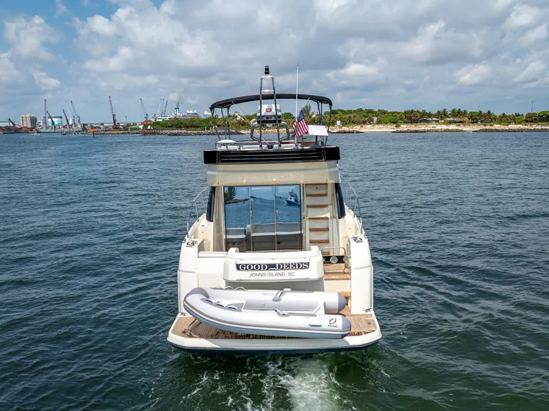 Slide: The Image of 2015 Beneteau Monte Carlo 5 yacht on water, rear view with inflatable boat. - 6