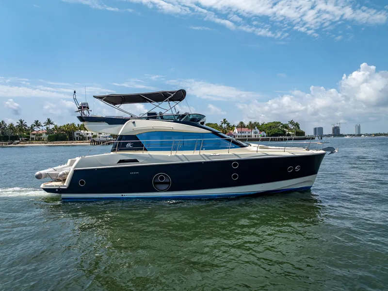 Slide: The Image of 2015 Beneteau Monte Carlo 5 yacht cruising on a sunny day near the coastline. - 9