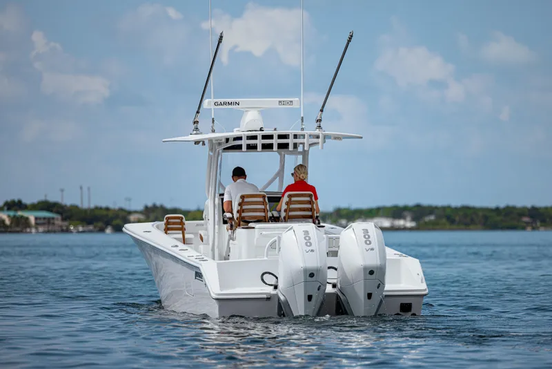 Slide: The Image of 2026 Jupiter 32 boat with dual engines cruising on a calm sea. - 2