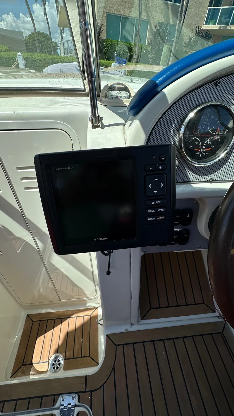 Slide: The Image of 2009 Chris-Craft Corsair 25 dashboard with navigation system and wooden flooring. - 15