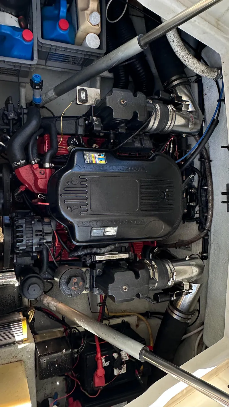 Slide: The Image of Engine compartment of a 2009 Chris-Craft Corsair 25 boat, showcasing detailed mechanical components. - 23